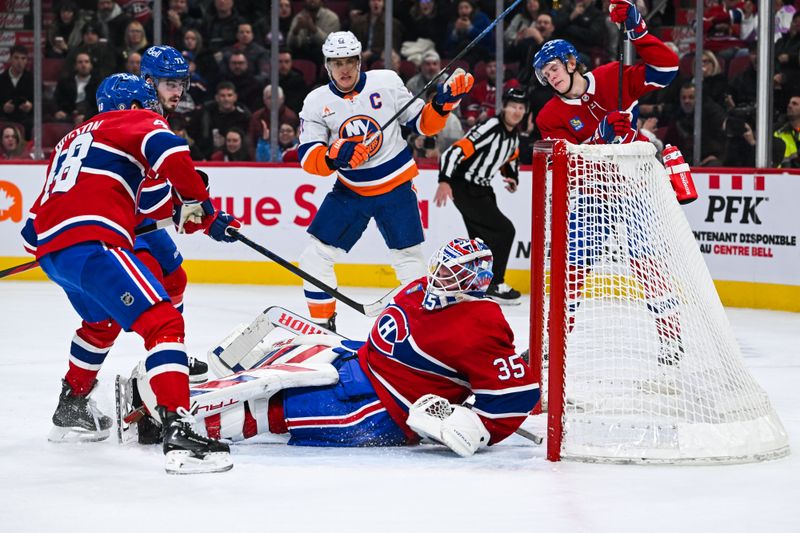 Dec 3, 2024; Montreal, Quebec, CAN; New York Islanders left wing Anders Lee (27) scores a goal against Montreal Canadiens goalie Sam Montembeault (35) during the second period at Bell Centre. Mandatory Credit: David Kirouac-Imagn Images