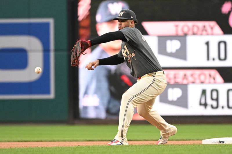 Aug 31, 2024; Washington, District of Columbia, USA; Washington Nationals second baseman Luis Garcia Jr. (2) misplays a throw to second base against the Chicago Cubs during the seventh inning at Nationals Park. Mandatory Credit: Rafael Suanes-USA TODAY Sports