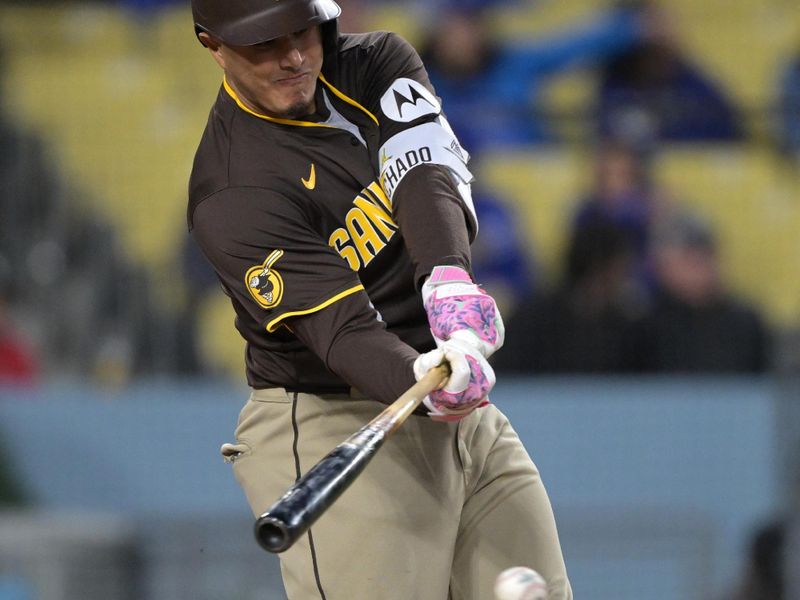 Apr 14, 2024; Los Angeles, California, USA; San Diego Padres designated hitter Manny Machado (13) singles in the ninth inning against the Los Angeles Dodgers at Dodger Stadium. Mandatory Credit: Jayne Kamin-Oncea-USA TODAY Sports