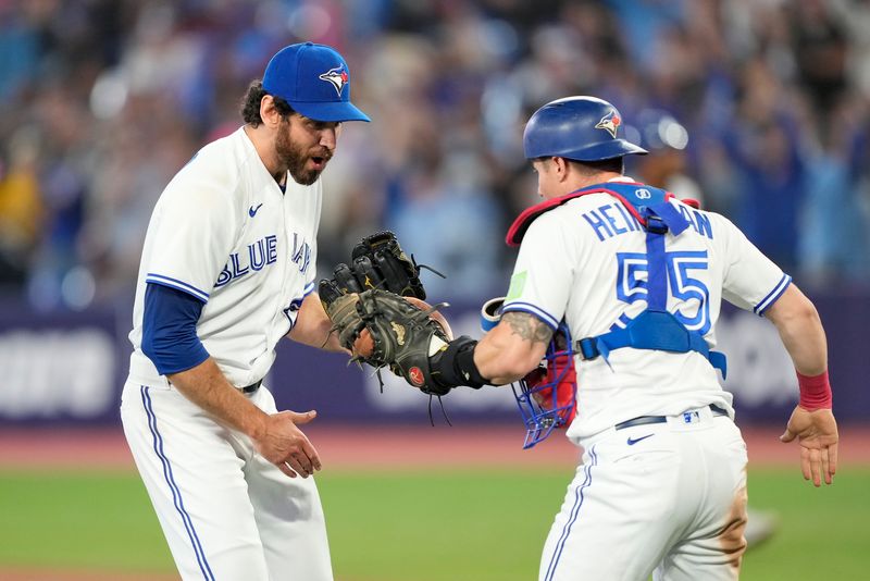 Sep 8, 2023; Toronto, Ontario, CAN; Toronto Blue Jays pitcher Jordan Romano (68) and catcher Tyler Heineman (55) celebrate a win over the Kansas City Royals at Rogers Centre. Mandatory Credit: John E. Sokolowski-USA TODAY Sports