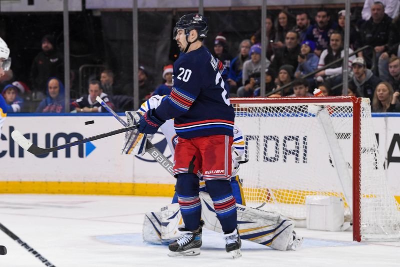 Dec 23, 2023; New York, New York, USA; New York Rangers left wing Chris Kreider (20) attempts to deflect the puck in front of Buffalo Sabres goaltender Ukko-Pekka Luukkonen (1) during the third period at Madison Square Garden. Mandatory Credit: Dennis Schneidler-USA TODAY Sports
