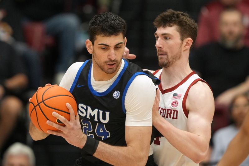 Feb 28, 2026; Stanford, California, USA; Southern Methodist University Mustangs center Samet Yigitoglu (24) handles the ball against Stanford Cardinal forward AJ Rohosy (right) during the first half at Maples Pavilion. Mandatory Credit: Darren Yamashita-Imagn Images