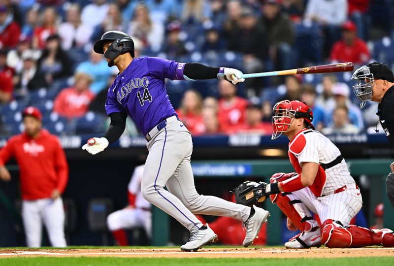 Apr 17, 2024; Philadelphia, Pennsylvania, USA; Colorado Rockies shortstop Ezequiel Tovar (14) hits a single against the Philadelphia Phillies in the first inning at Citizens Bank Park. Mandatory Credit: Kyle Ross-USA TODAY Sports