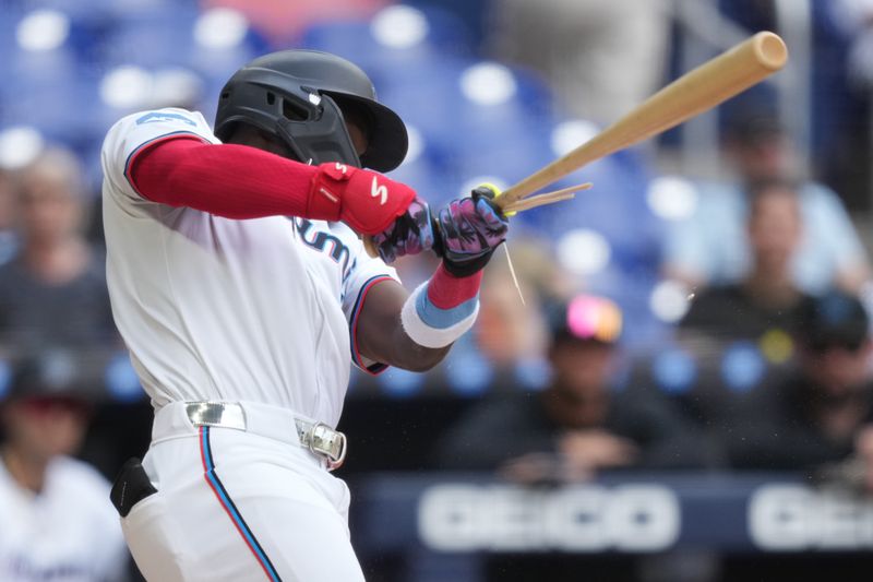 Apr 23, 2025; Miami, Florida, USA;  Miami Marlins left fielder Ronny Simon (41) shatters his bat in the seventh inning against the Cincinnati Reds at loanDepot Park. Mandatory Credit: Jim Rassol-Imagn Images