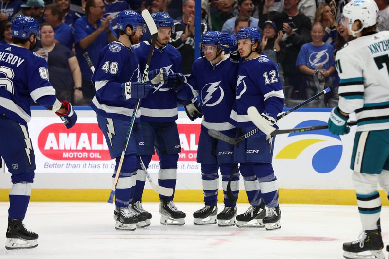 Oct 26, 2023; Tampa, Florida, USA; Tampa Bay Lightning center Brayden Point (21) is congratulated after he scored a goal against the San Jose Sharks during the first period at Amalie Arena. Mandatory Credit: Kim Klement Neitzel-USA TODAY Sports