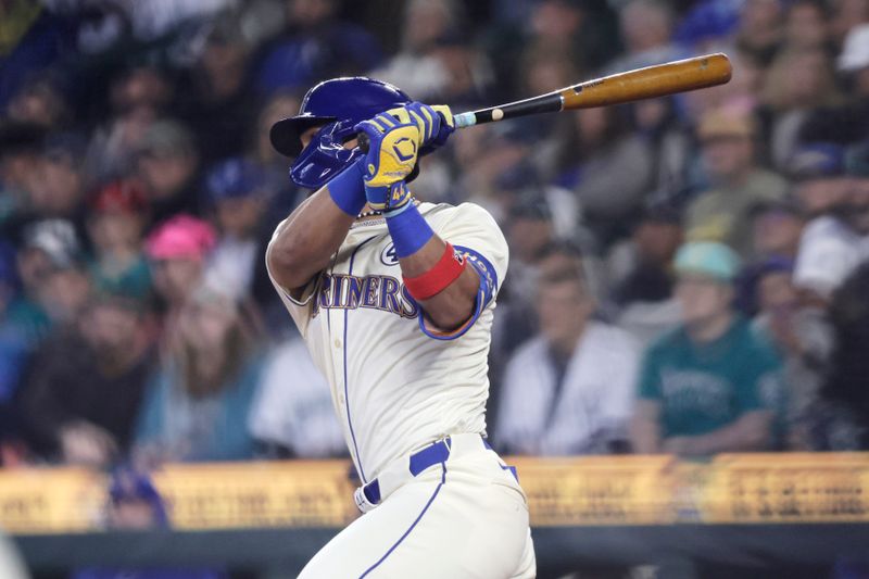 Jun 2, 2024; Seattle, Washington, USA;  Seattle Mariners center fielder Julio Rodríguez (44) hits and reaches second on a fielders choice against the Los Angeles Angels during the first inning at T-Mobile Park. Mandatory Credit: John Froschauer-USA TODAY Sports