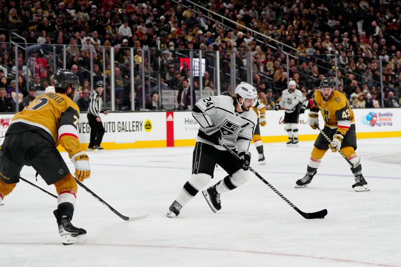 Dec 28, 2023; Las Vegas, Nevada, USA; Los Angeles Kings center Phillip Danault (24) skates with the puck against the Vegas Golden Knights during the third period at T-Mobile Arena. Mandatory Credit: Lucas Peltier-USA TODAY Sports