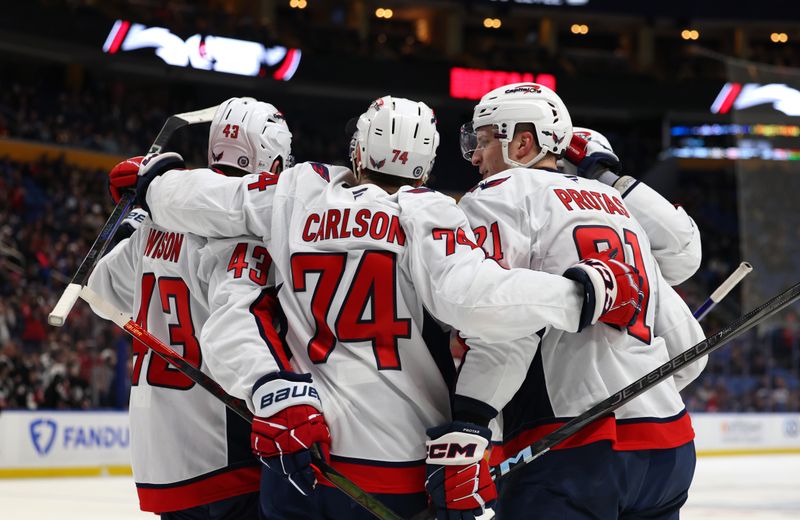 Jan 6, 2025; Buffalo, New York, USA;  Washington Capitals center Aliaksei Protas (21) celebrates his goal with teammates during the third period against the Buffalo Sabres at KeyBank Center. Mandatory Credit: Timothy T. Ludwig-Imagn Images