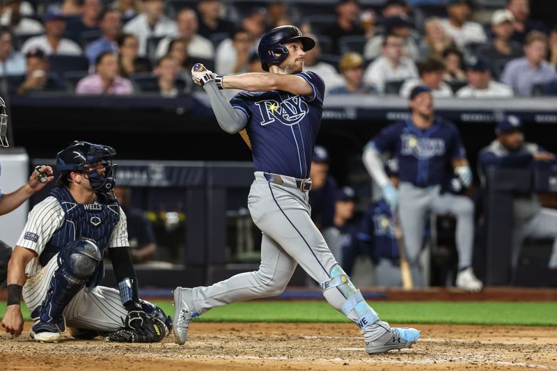 Jul 19, 2024; Bronx, New York, USA;  Tampa Bay Rays right fielder Josh Lowe (15) hits a solo home run in the sixth inning against the New York Yankees at Yankee Stadium. Mandatory Credit: Wendell Cruz-USA TODAY Sports