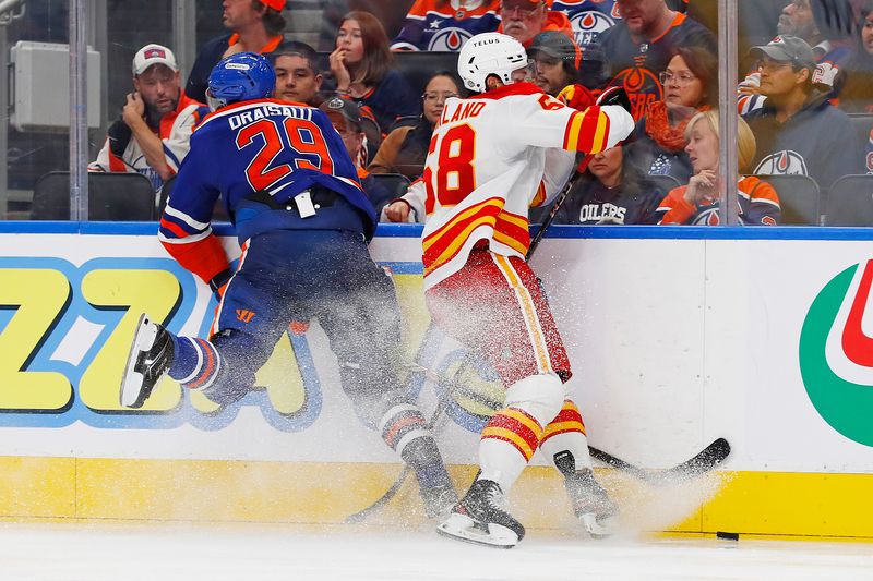 Oct 13, 2024; Edmonton, Alberta, CAN; Calgary Flames forward Justin Kirkland (58) checks Edmonton Oilers forward Leon Draisaitl (29) during the third period at Rogers Place. Mandatory Credit: Perry Nelson-Imagn Images