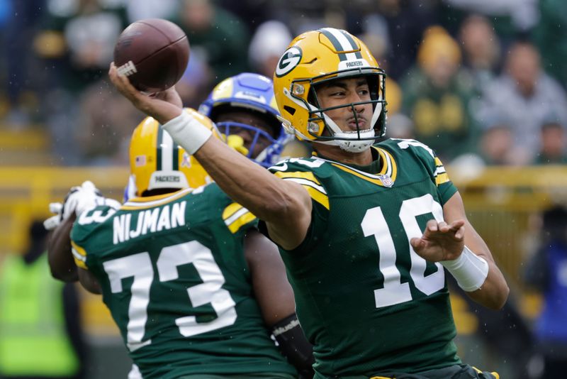 Green Bay Packers quarterback Jordan Love (10) passes during the first half of an NFL football game against the Los Angeles Rams, Sunday, Nov. 5, 2023, in Green Bay, Wis. (AP Photo/Mike Roemer)