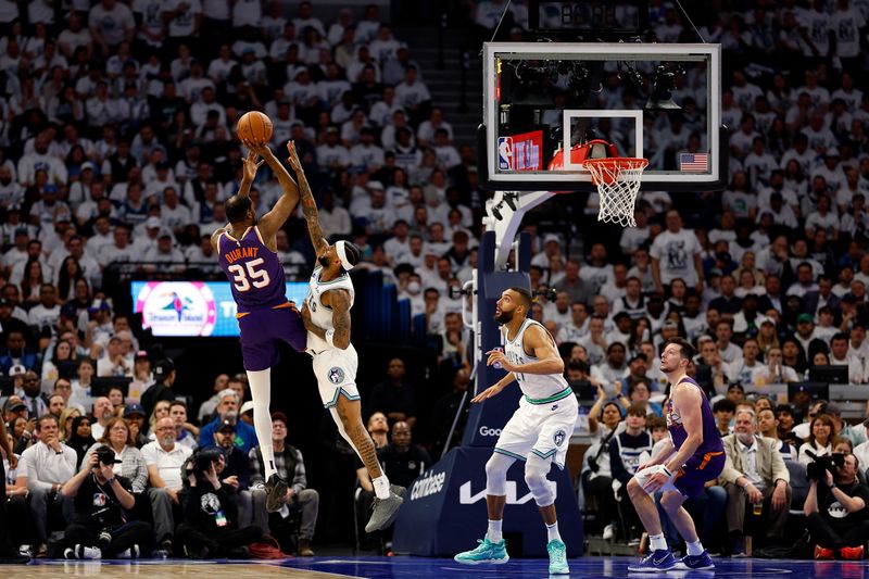 MINNEAPOLIS, MINNESOTA - APRIL 23: Kevin Durant #35 of the Phoenix Suns shoot against Nickeil Alexander-Walker #9 of the Minnesota Timberwolves in the second quarter of game two of the Western Conference First Round Playoffs at Target Center on April 23, 2024 in Minneapolis, Minnesota. NOTE TO USER: User expressly acknowledges and agrees that, by downloading and or using this photograph, User is consenting to the terms and conditions of the Getty Images License Agreement. (Photo by David Berding/Getty Images)