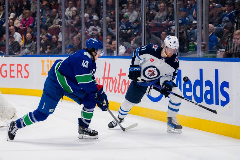 Mar 9, 2024; Vancouver, British Columbia, CAN; Vancouver Canucks defenseman Quinn Hughes (43) battles with Winnipeg Jets forward Kyle Connor (81) in the third period at Rogers Arena. Canucks won 5-0. Mandatory Credit: Bob Frid-USA TODAY Sports