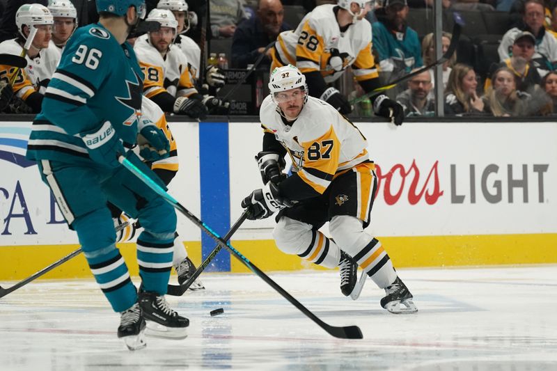 Jan 27, 2025; San Jose, California, USA; Pittsburgh Penguins center Sidney Crosby (87) advances the puck toward San Jose Sharks defenseman Jake Walman (96) during the first period at SAP Center at San Jose. Mandatory Credit: David Gonzales-Imagn Images