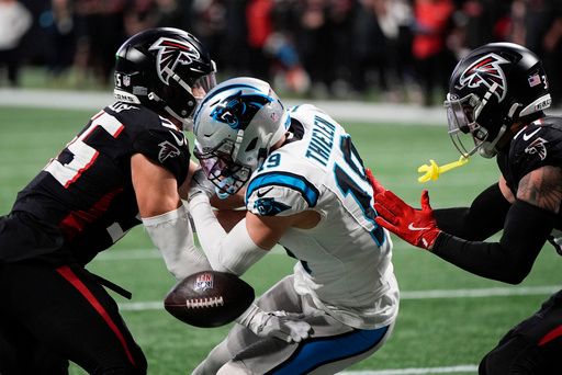 Carolina Panthers wide receiver Adam Thielen (19) is hit by the Atlanta Falcons during the second half of an NFL football game against the Carolina Panthers, Sunday, Jan. 5, 2025, in Atlanta. (AP Photo/Mike Stewart)