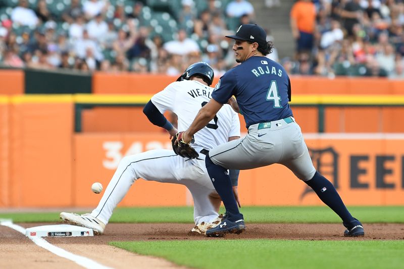 Aug 13, 2024; Detroit, Michigan, USA;  Detroit Tigers right fielder Matt Vierling (8) slides safely into third base after the ball gets away from Seattle Mariners third baseman Josh Rojas (4) in the first inning at Comerica Park. Mandatory Credit: Lon Horwedel-USA TODAY Sports