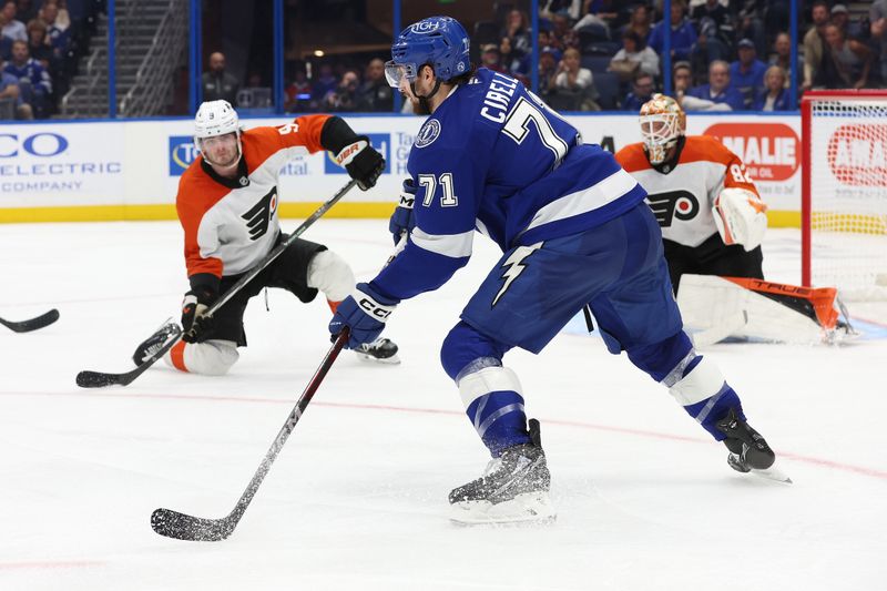 Nov 7, 2024; Tampa, Florida, USA; Tampa Bay Lightning center Anthony Cirelli (71) passes the puck as Philadelphia Flyers defenseman Jamie Drysdale (9) defends during the third period at Amalie Arena. Mandatory Credit: Kim Klement Neitzel-Imagn Images