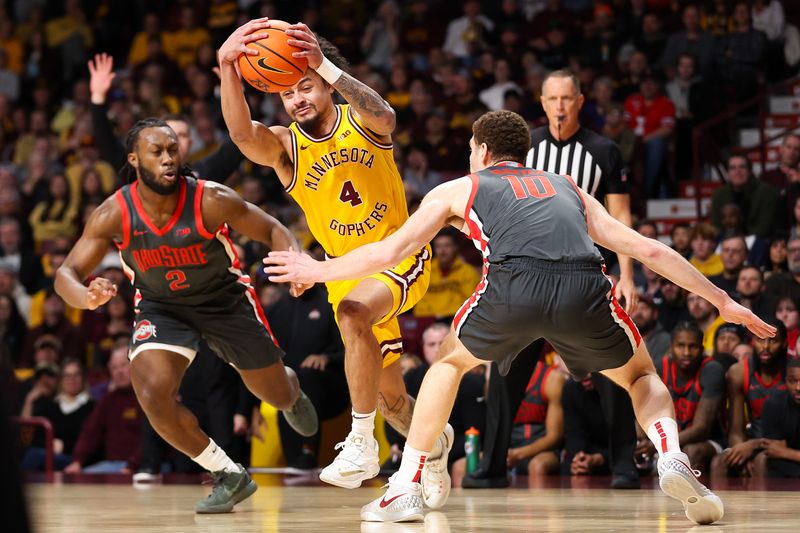 Feb 22, 2024; Minneapolis, Minnesota, USA; Minnesota Golden Gophers guard Braeden Carrington (4) works towards the basket as Ohio State Buckeyes forward Jamison Battle (10) and guard Bruce Thornton (2) defend during the first half at Williams Arena. Mandatory Credit: Matt Krohn-USA TODAY Sports