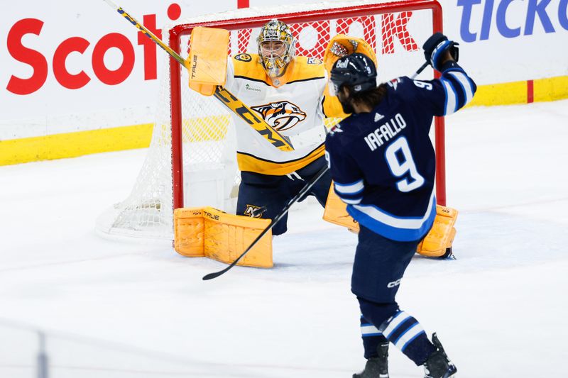 Mar 13, 2024; Winnipeg, Manitoba, CAN; Winnipeg Jets forward Alex Iafallo (9) scores on Nashville Predators goalie Juuse Saros (74) during the third period at Canada Life Centre. Mandatory Credit: Terrence Lee-USA TODAY Sports