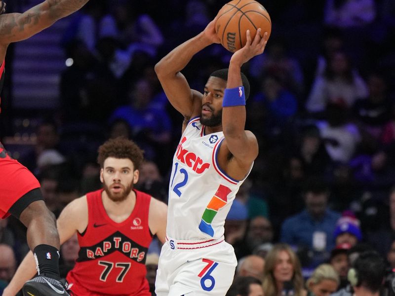 PHILADELPHIA, PA - FEBRUARY 11:  Jared Butler #12 of the Philadelphia 76ers looks to pass the ball during the game against the Toronto Raptors  on February 11, 2025 at the Wells Fargo Center in Philadelphia, Pennsylvania NOTE TO USER: User expressly acknowledges and agrees that, by downloading and/or using this Photograph, user is consenting to the terms and conditions of the Getty Images License Agreement. Mandatory Copyright Notice: Copyright 2025 NBAE (Photo by Jesse D. Garrabrant/NBAE via Getty Images)