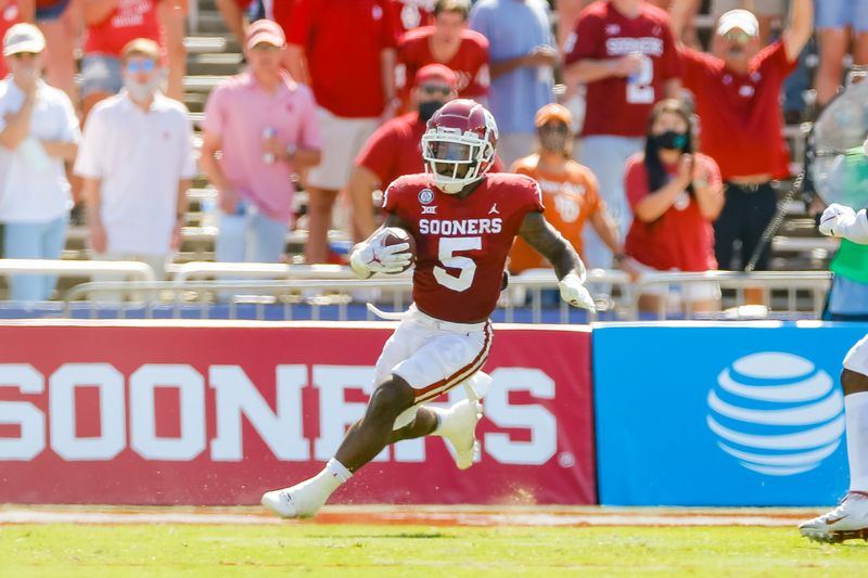 Oct 10, 2020; Dallas, Texas, USA; Oklahoma Sooners running back T.J. Pledger (5) runs wide against the Texas Longhorns during the first quarter of the Red River Showdown at Cotton Bowl. Mandatory Credit: Andrew Dieb-USA TODAY Sports