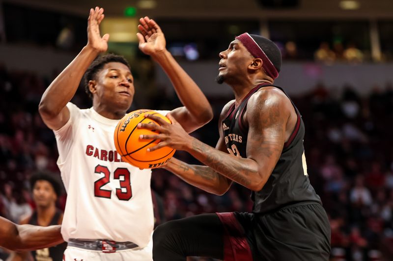 Jan 14, 2023; Columbia, South Carolina, USA; Texas A&M Aggies guard Tyrece Radford (23) drives past South Carolina Gamecocks forward Gregory Jackson II (23) in the second half at Colonial Life Arena. Mandatory Credit: Jeff Blake-USA TODAY Sports