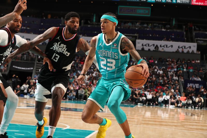 CHARLOTTE, NC - MARCH 31: Tre Mann #23 of the Charlotte Hornets handles the ball against Norman Powell #24 and Paul George #13 of the LA Clippers during the game on March 31, 2024 at Spectrum Center in Charlotte, North Carolina. NOTE TO USER: User expressly acknowledges and agrees that, by downloading and or using this photograph, User is consenting to the terms and conditions of the Getty Images License Agreement. Mandatory Copyright Notice: Copyright 2024 NBAE (Photo by Kent Smith/NBAE via Getty Images)