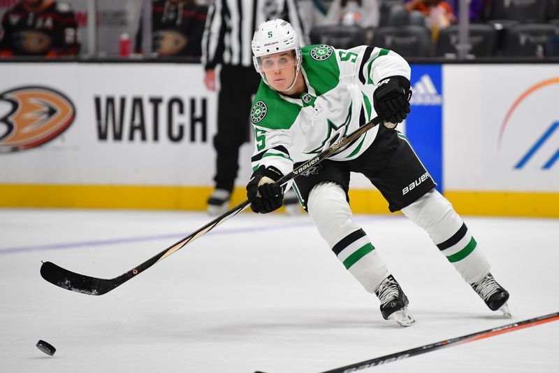 Oct 19, 2023; Anaheim, California, USA; Dallas Stars defenseman Nils Lundkvist (5) passes the puck against the Anaheim Ducks during the first period at Honda Center. Mandatory Credit: Gary A. Vasquez-USA TODAY Sports