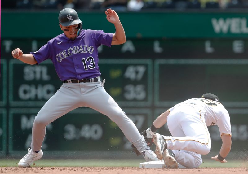 May 10, 2023; Pittsburgh, Pennsylvania, USA;  Colorado Rockies second baseman Alan Trejo (13) is safe after stealing second base as Pittsburgh Pirates shortstop Chris Owings (right) attempts a tag during the fourth inning at PNC Park. Mandatory Credit: Charles LeClaire-USA TODAY Sports