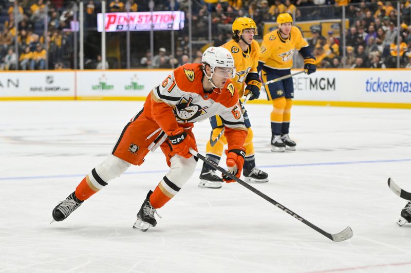 Mar 20, 2025; Nashville, Tennessee, USA;  Anaheim Ducks left wing Cutter Gauthier (61) skates with the puck against the Nashville Predators during the second period at Bridgestone Arena. Mandatory Credit: Steve Roberts-Imagn Images