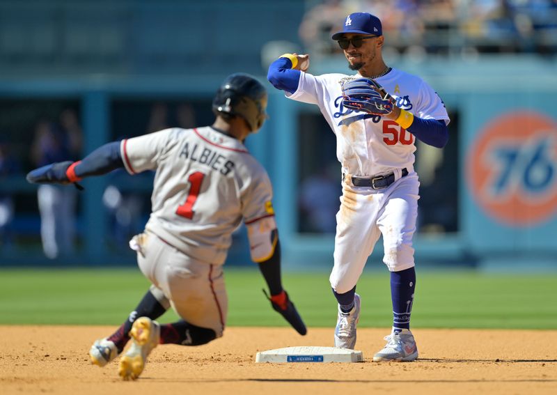 Sep 3, 2023; Los Angeles, California, USA;  Atlanta Braves second baseman Ozzie Albies (1) is out at first as Los Angeles Dodgers right fielder Mookie Betts (50) throws to first for a double play in the ninth inning at Dodger Stadium. Mandatory Credit: Jayne Kamin-Oncea-USA TODAY Sports