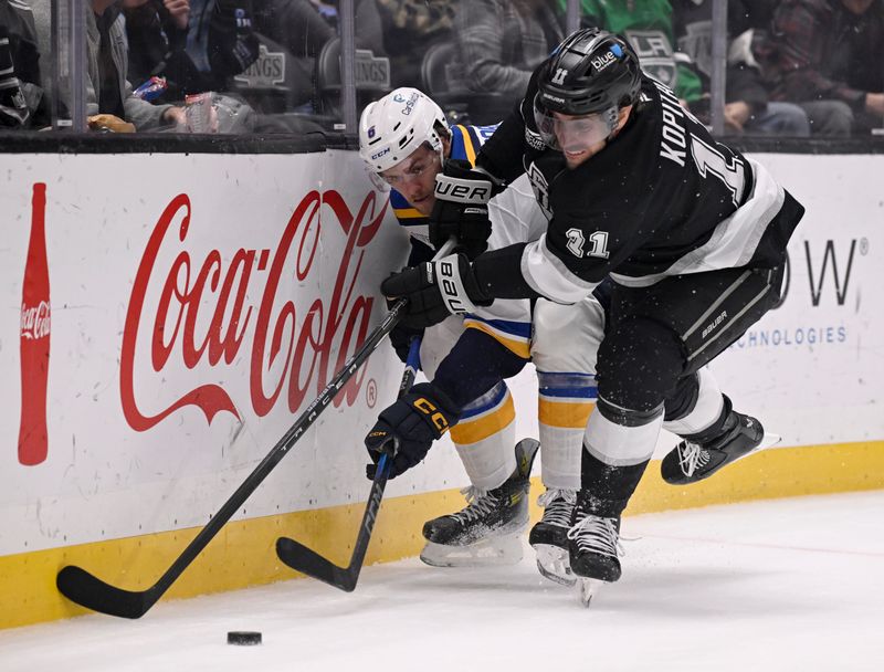 Mar 5, 2025; Los Angeles, California, USA;  Los Angeles Kings center Anze Kopitar (11) vies for the puck with St. Louis Blues defenseman Philip Broberg (6) during the first period at Crypto.com Arena. Mandatory Credit: Alex Gallardo-Imagn Images