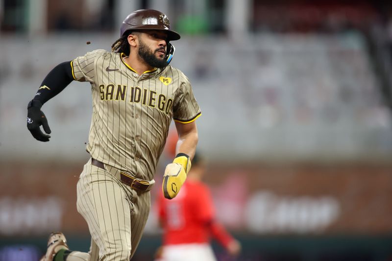 May 17, 2024; Atlanta, Georgia, USA; San Diego Padres right fielder Fernando Tatis Jr. (23) runs to third against the Atlanta Braves in the fifth inning at Truist Park. Mandatory Credit: Brett Davis-USA TODAY Sports