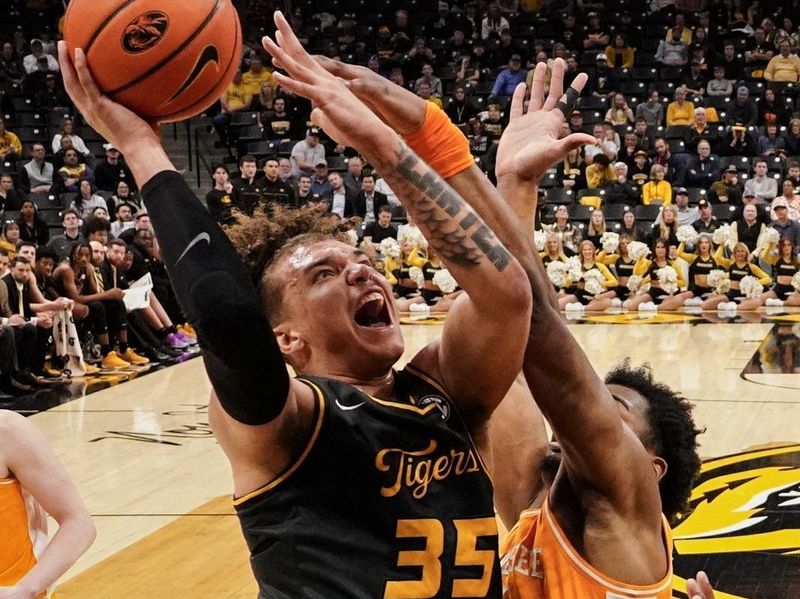 Feb 20, 2024; Columbia, Missouri, USA; Missouri Tigers forward Noah Carter (35) shoots as Tennessee Volunteers guard Jahmai Mashack (15) defends during the first half at Mizzou Arena. Mandatory Credit: Denny Medley-USA TODAY Sports