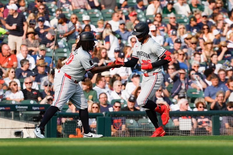 Jul 26, 2024; Detroit, Michigan, USA; Minnesota Twins outfielder Byron Buxton (25) high-fives Minnesota Twins third base coach Tommy Watkins (40) after scoring a home run in the first inning of the game against the Detroit Tigers at Comerica Park. Mandatory Credit: Brian Bradshaw Sevald-USA TODAY Sports