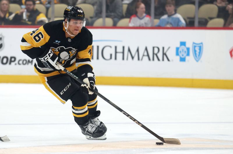 Mar 21, 2025; Pittsburgh, Pennsylvania, USA;  Pittsburgh Penguins center Blake Lizotte (46) skates up ice with the puck against the Columbus Blue Jackets during the first period at PPG Paints Arena. Mandatory Credit: Charles LeClaire-Imagn Images
