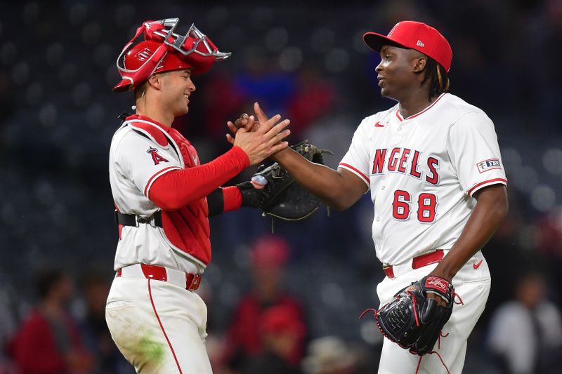 May 6, 2025; Anaheim, California, USA; Los Angeles Angels catcher Logan O'Hoppe (14) and pitcher Jose Fermin (68) celebrate the victory against the Toronto Blue Jays at Angel Stadium. Mandatory Credit: Gary A. Vasquez-Imagn Images