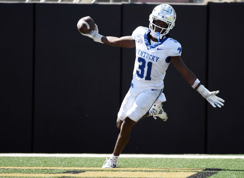 Sep 23, 2023; Nashville, Tennessee, USA; Kentucky Wildcats defensive back Maxwell Hairston (31) celebrates after after scoring his second touchdown on an interception against the Vanderbilt Commodores at FirstBank Stadium. Mandatory Credit: Christopher Hanewinckel-USA TODAY Sports