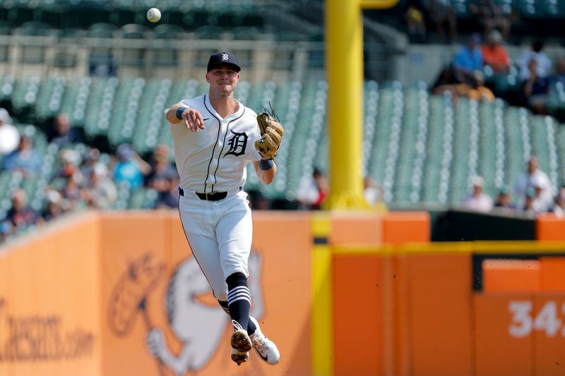 Sep 12, 2024; Detroit, Michigan, USA;  Detroit Tigers shortstop Trey Sweeney (27) makes a throw in the first inning against the Colorado Rockies at Comerica Park. Mandatory Credit: Rick Osentoski-Imagn Images