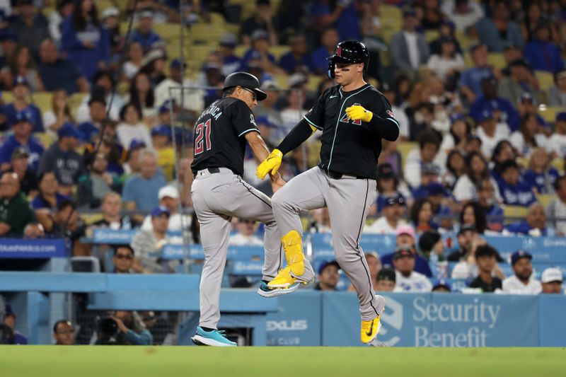 Jul 2, 2024; Los Angeles, California, USA;  Arizona Diamondbacks designated hitter Joc Pederson (3) celebrates with third base coach Tony Perezchica (21) after hitting a home run during the ninth inning against the Los Angeles Dodgers at Dodger Stadium. Mandatory Credit: Kiyoshi Mio-USA TODAY Sports