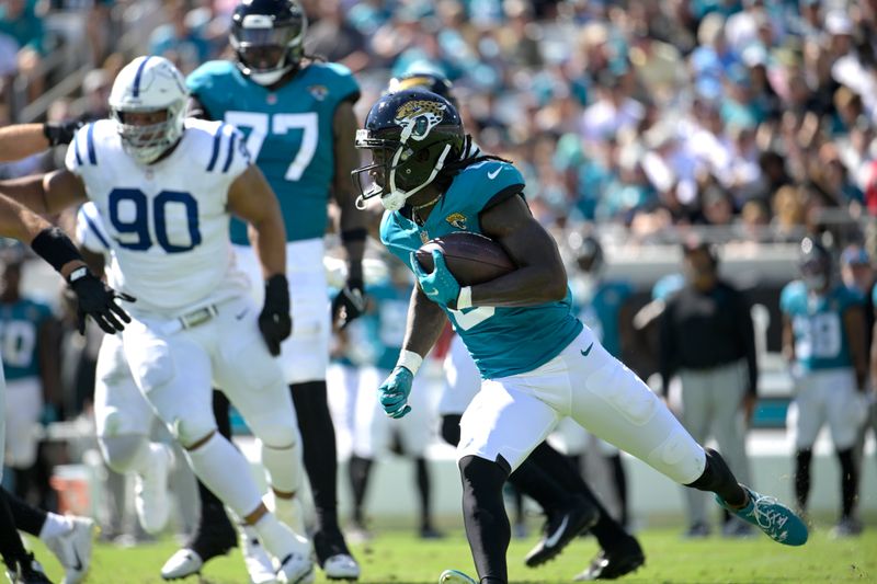 Jacksonville Jaguars wide receiver Calvin Ridley (0) runs after taking the hand off from quarterback Trevor Lawrence during the second half of an NFL football game against the Indianapolis Colts, Sunday, Oct. 15, 2023, in Jacksonville, Fla. (AP Photo/Phelan M. Ebenhack)