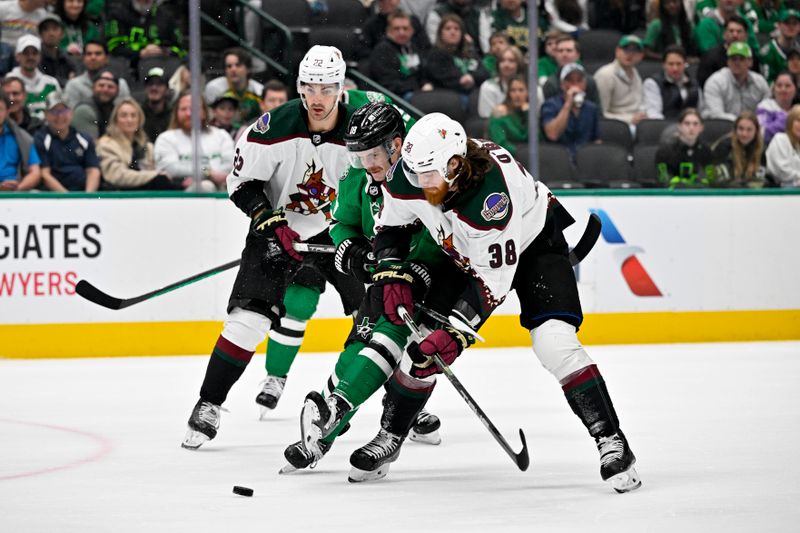 Mar 20, 2024; Dallas, Texas, USA; Dallas Stars center Sam Steel (18) and Arizona Coyotes center Liam O'Brien (38) battle for control of the puck during the first period at the American Airlines Center. Mandatory Credit: Jerome Miron-USA TODAY Sports