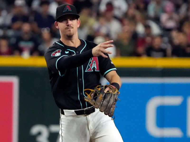 May 26, 2024; Phoenix, Arizona, USA; Arizona Diamondbacks shortstop Kevin Newman (18) makes the play for an out against the Miami Marlins in the first inning at Chase Field. Mandatory Credit: Rick Scuteri-USA TODAY Sports