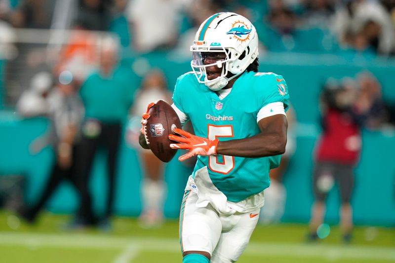 Miami Dolphins quarterback Teddy Bridgewater (5) looks to pass the ball during the first half of a NFL preseason football game against the Las Vegas Raiders, Saturday, Aug. 20, 2022, in Miami Gardens, Fla. (AP Photo/Lynne Sladky)