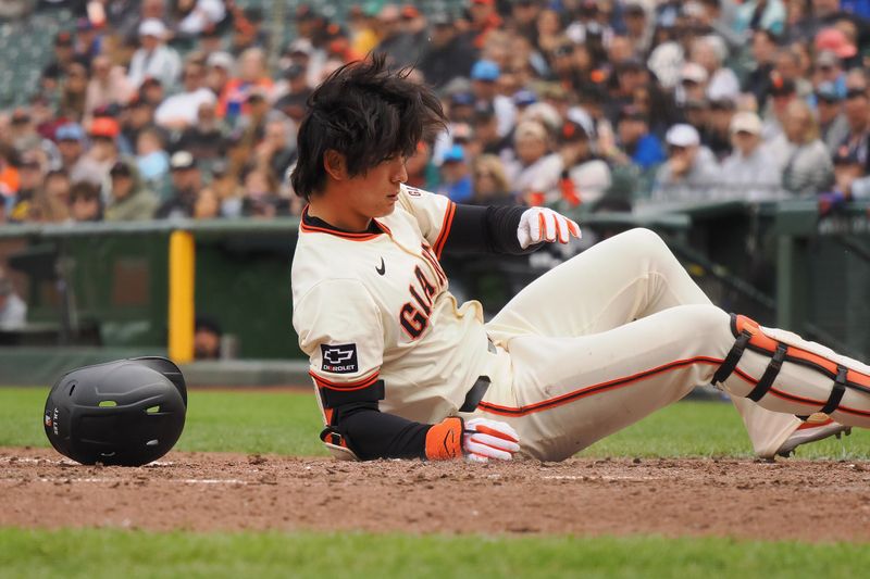 Apr 24, 2024; San Francisco, California, USA; San Francisco Giants center fielder Jung Hoo Lee (51) earns a walk after falling to the ground while avoiding the ball during the eighth inning against the New York Mets at Oracle Park. Mandatory Credit: Kelley L Cox-USA TODAY Sports