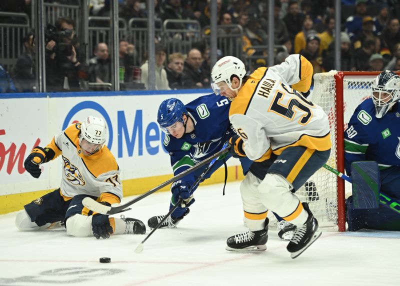 Mar 12, 2026; Vancouver, British Columbia, CAN;Vancouver Canucks defenseman Tom Willander (5) checks Nashville Predators right wing Luke Evangelista (77) and left wing Erik Haula (56) during the first period at Rogers Arena. Mandatory Credit: Simon Fearn-Imagn Images