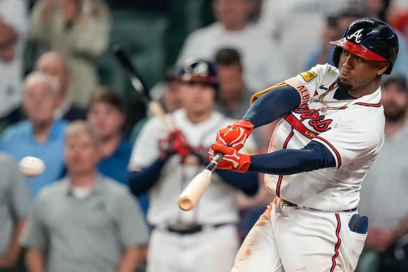 Sep 27, 2023; Cumberland, Georgia, USA; Atlanta Braves second baseman Ozzie Albies (1) gets the game winning hit against the Chicago Cubs during the tenth inning at Truist Park. Mandatory Credit: Dale Zanine-USA TODAY Sports