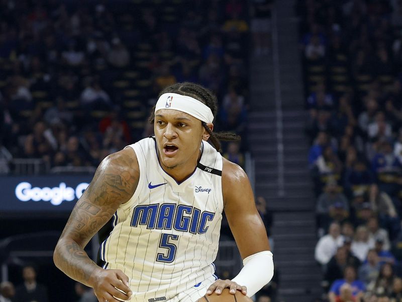 SAN FRANCISCO, CALIFORNIA - FEBRUARY 03: Paolo Banchero #5 of the Orlando Magic dribbles the ball against the Golden State Warriors during the first half of an NBA basketball game at Chase Center on February 03, 2025 in San Francisco, California. NOTE TO USER: User expressly acknowledges and agrees that, by downloading and or using this photograph, User is consenting to the terms and conditions of the Getty Images License Agreement.  (Photo by Thearon W. Henderson/Getty Images)