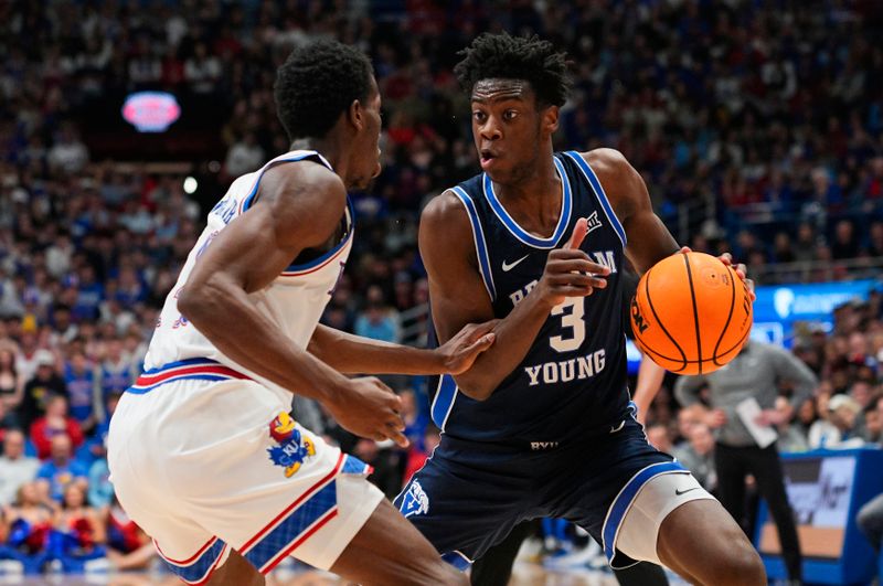 Jan 31, 2026; Lawrence, Kansas, USA; BYU Cougars forward AJ Dybantsa (3) drives against Kansas Jayhawks guard Melvin Council Jr. (14) during the first half at Allen Fieldhouse. Mandatory Credit: Jay Biggerstaff-Imagn Images