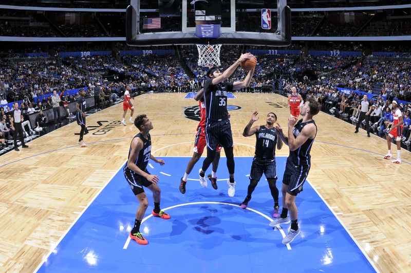 ORLANDO, FL - NOVMEBER 10: Goga Bitadze #35 of the Orlando Magic goes up for the rebound during the game against the Washington Wizards on November 10, 2024 at Kia Center in Orlando, Florida. NOTE TO USER: User expressly acknowledges and agrees that, by downloading and or using this photograph, User is consenting to the terms and conditions of the Getty Images License Agreement. Mandatory Copyright Notice: Copyright 2024 NBAE (Photo by Fernando Medina/NBAE via Getty Images)